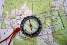 27234027-the-compass-lies-on-the-modern-world-map